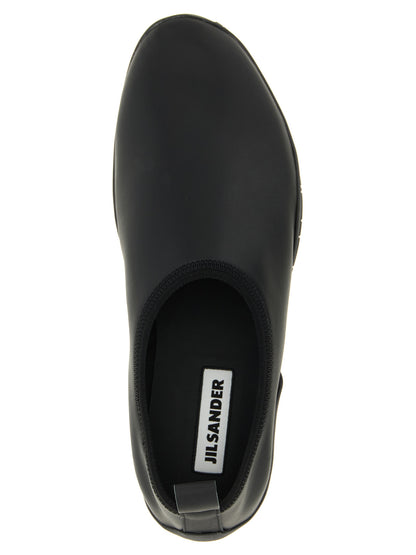 Slippers Flat Shoes by Jil Sander for women in polyester polyethylene polyurethane & rubber black showcases a dynamic silhouette, artfully capturing Women's Polyester Polyethylene Polyurethane & Rubber Slippers Flat Shoes through its distinctive and elegant .