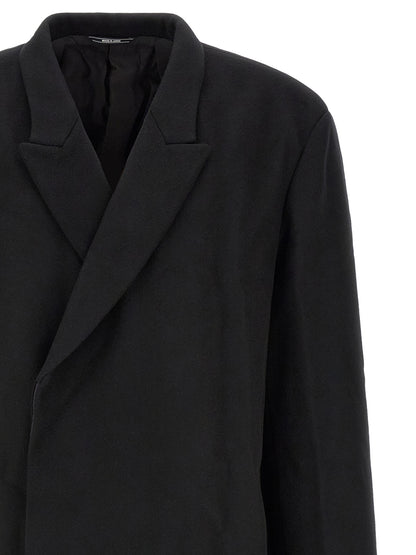 Overcoat by Kiko Kostadinov for men in satin wool black showcases a enveloping silhouette, detailed with distinctive and a enveloping .