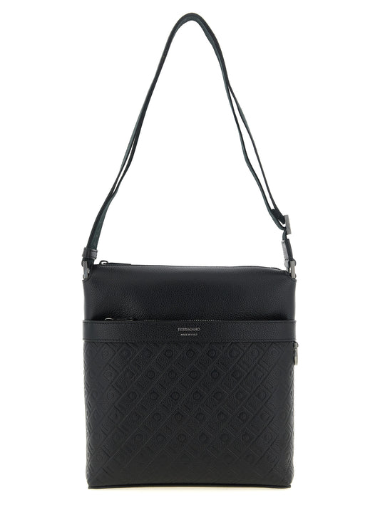 This Crossbody Messenger Bag by Ferragamo for men in calfskin & leather black & monogram presents a versatile silhouette from the Calfskin & Leather Crossbody Messenger Bag collection, featuring a secure zipper, ample , and versatile crossbody-strap, shoulder-strap & adjustable-strap.