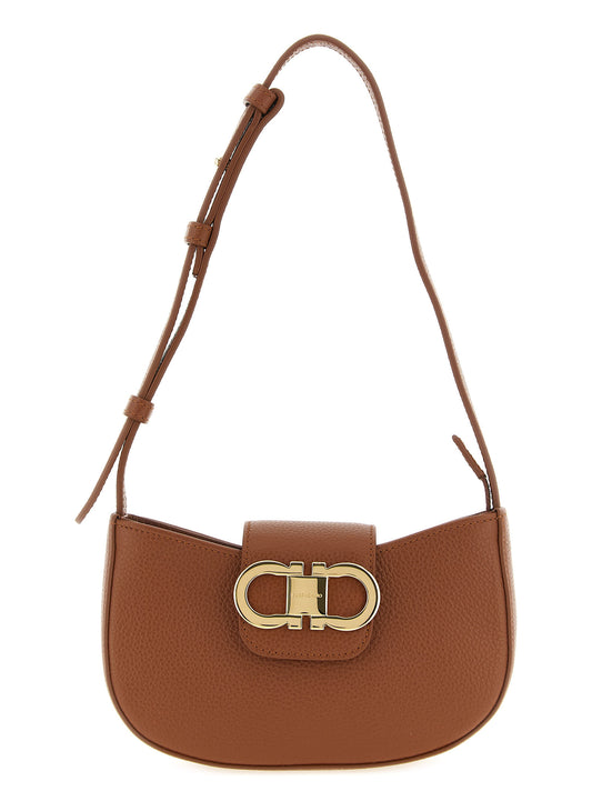 Mini Evening Crescent Shoulder Bag by Ferragamo for women in bos taurus calfskin leather brown & gold features a distinguished silhouette, showcasing a secure flap, zipper & magnetic and distinguished with versatile shoulder-strap & adjustable-strap for a distinguished finish.