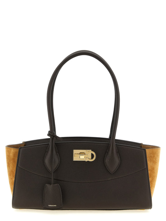 East West Shoulder Bag by Ferragamo for women in calfskin goat & suede leather brown & gold features a effortless chic silhouette with a secure , ample , and versatile shoulder-strap & handle for a effortless chic finish.