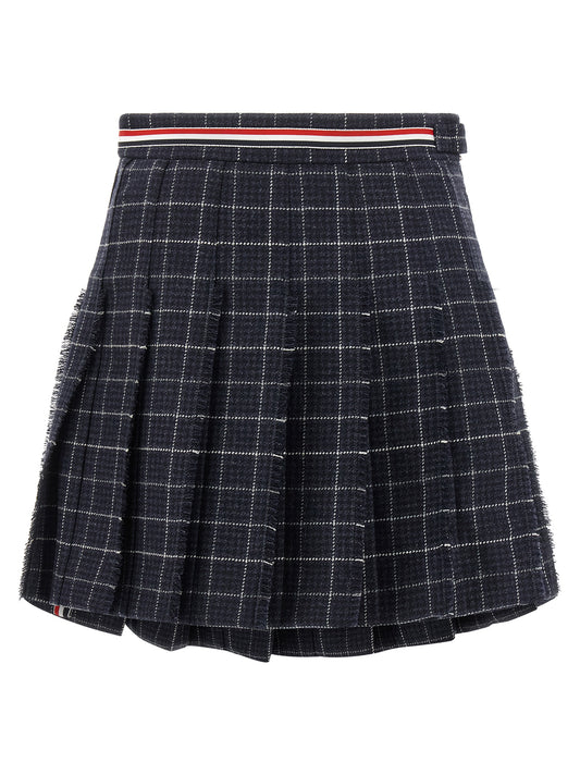 Skirt by Thom Browne for women in wool tweed blue, patterned, houndstooth & plaid showcases a sultry silhouette, elegantly defined by its mini long and the sophisticated sultry design of the Ribbon Women's Pleated Asymmetrical Wool Tweed Mini Long Skirt.