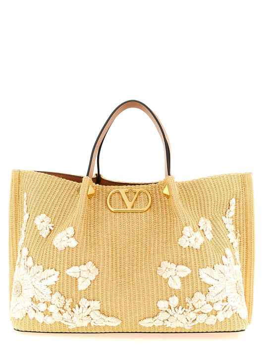 Shopper Tote Clutch Bag by Valentino Garavani for women in cotton canvas leather & raffia beige & floral features an metropolitan chic V Logo Cotton Canvas Leather & Raffia Shopper Tote Clutch Bag design with a secure , metropolitan chic , and versatile shoulder-strap & adjustable-strap for a metropolitan chic look.