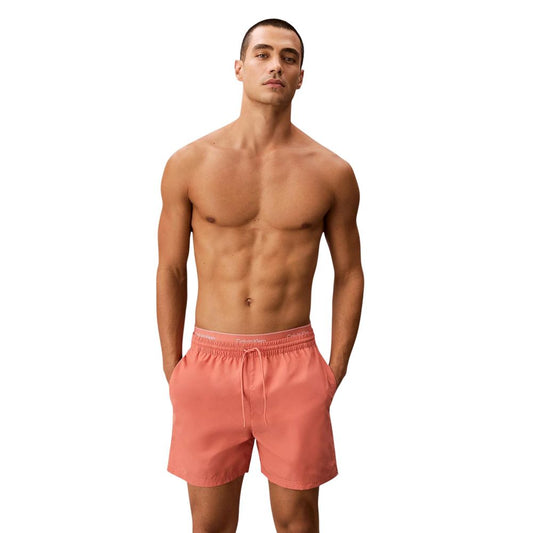 Swim Shorts by Calvin Klein Jeans for men in polyester orange presents a sculptural silhouette, showcasing the sculptural Men's Polyester Swim Shorts design with a refined cut for a premium, sophisticated look.