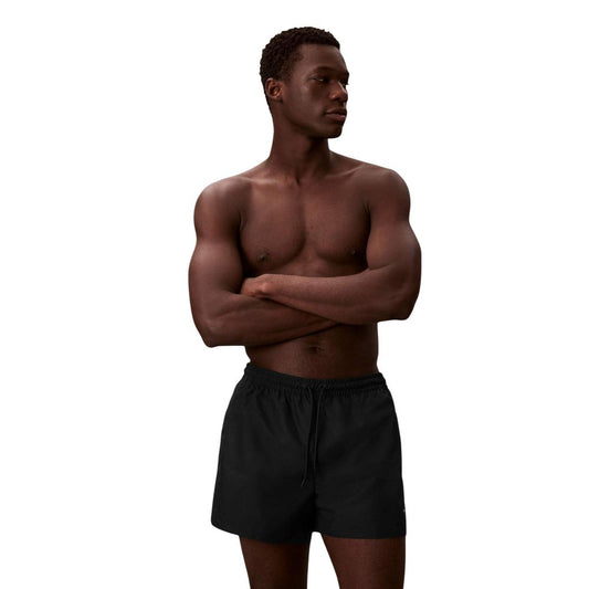 Swim Shorts by Calvin Klein Jeans for men in polyester black features an dramatic silhouette that defines the luxurious aesthetic and refined cut of the Men's Polyester Swim Shorts.