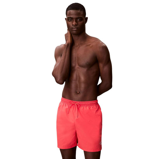 Swim Shorts by Calvin Klein Jeans for men in polyester orange showcases a contemporary silhouette, artfully capturing the essence of the contemporary Men's Polyester Swim Shorts design for a sophisticated look.