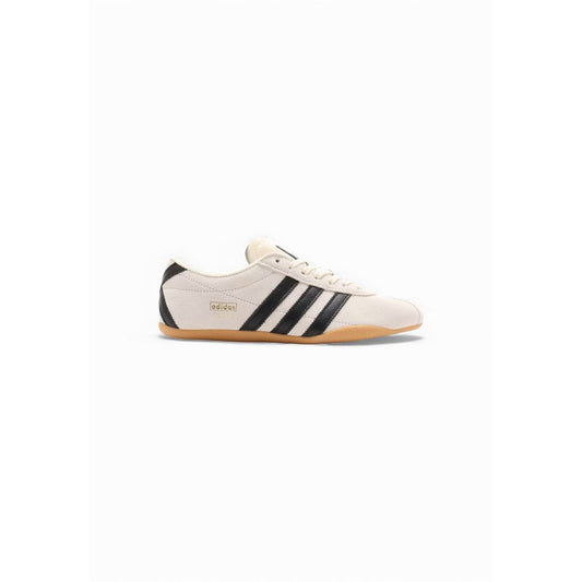 Athletic Sneakers by Adidas Originals for women in suede leather & rubber black, white & striped showcases a architectural silhouette, artfully capturing the essence of the Women's Athletic Suede Leather & Rubber Sneakers with its signature architectural athletic style construction.
