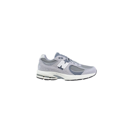 Athletic Sneakers by New Balance for women in leather plush & rubber gray & signature showcases a architectural silhouette, artfully capturing the essence of the Women's Athletic Leather Plush & Rubber Sneakers with its signature architectural athletic style construction.