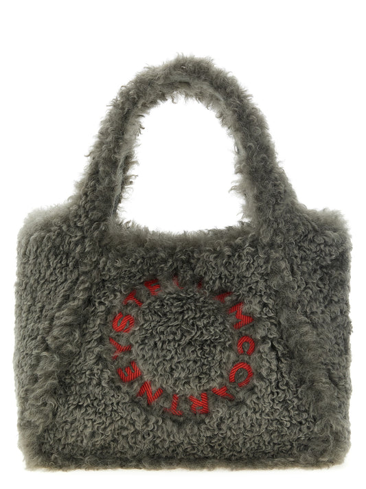 Tote Clutch Bag by Stella McCartney for women in nappa leather plush & polyester gray features an utilitarian-chic silhouette, showcasing the Nappa Leather Plush & Polyester Tote Clutch Bag design with a secure magnetic, ample , and versatile shoulder-strap, handle, adjustable-strap & detachable-strap.