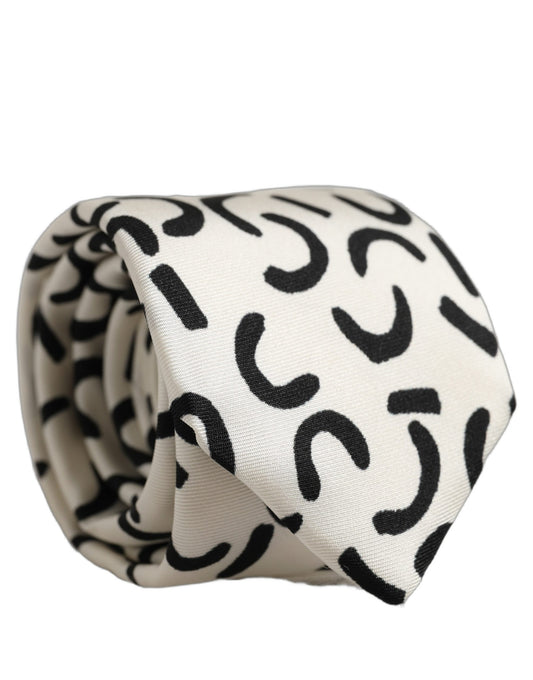 Necktie by Dolce & Gabbana for men in silk black, cream & patterned features a distinguished silhouette, artfully capturing the essence of the distinguished Silk Necktie design for a sophisticated look.