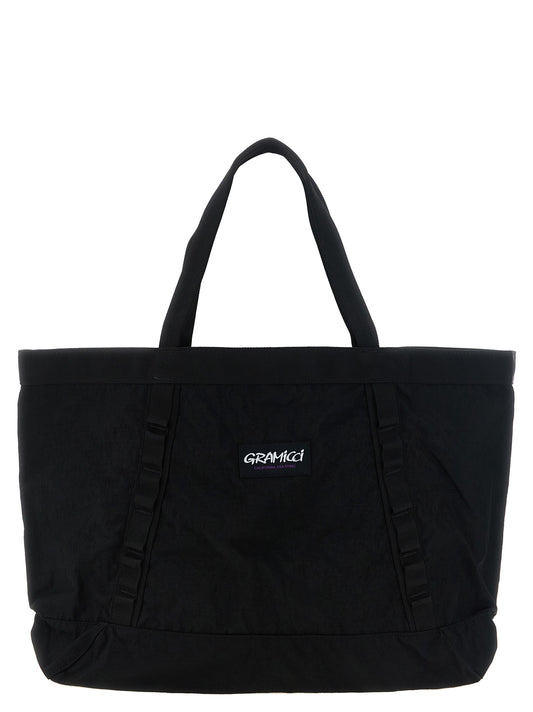Large Tote Bag by Gramicci for men in canvas cordura metal & nylon black features an metropolitan chic Cordura Canvas Metal & Nylon Large Tote Bag design with a secure zipper, metropolitan chic , and versatile handle for a metropolitan chic look.
