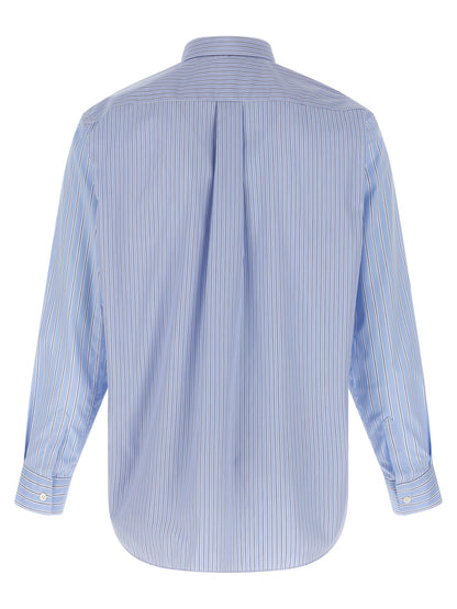 Shirt by Comme Des Garçons for men in cotton blue, patterned, patchwork & striped features an architectural silhouette with a refined and elegant for a architectural look.