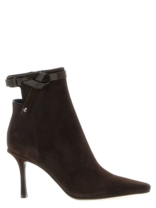 Stiletto Ankle Cut-Out Strap Boots by Jimmy Choo for women in suede leather brown showcases a ergonomic silhouette from the Women's Suede Leather Stiletto Ankle Cut-Out Strap Boots collection, featuring a ergonomic stiletto and a ergonomic square toe style.