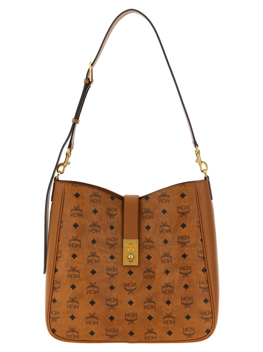 Shoulder Bag by MCM for women in cotton polyester canvas & suede leather brown, gold & monogram features a enviable silhouette, showcasing a secure zipper & turn-lock, ample , and enviable shoulder-strap for a enviable finish.