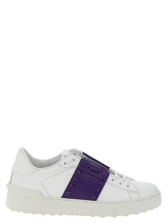 Sneakers by Valentino Garavani for women in calfskin leather gold, purple & white features a chic design, perfectly showcasing the chic low-top style of this Rockstud Women's Low Top Calfskin Leather Sneakers.