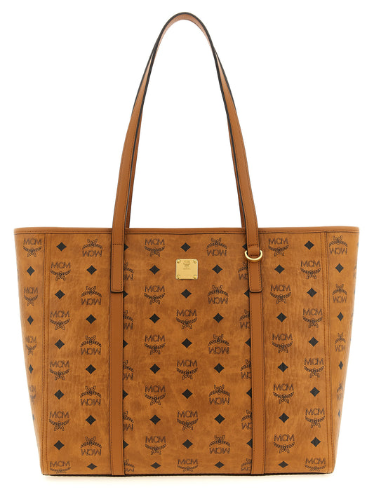 This Medium Shopper Tote Bag by MCM for women in canvas metal & polyethylene brown, monogram & print features an on trend Visetos Canvas Metal & Polyethylene Medium Shopper Tote Bag design with a secure zipper, ample , and on trend handle.