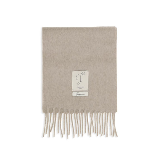 Scarf by Jacquemus for men in wool beige, black, white & signature features a snug silhouette, perfectly showcasing the elegant drape and premium finish of the Wool Shawl Fringes Scarf.