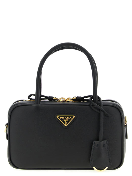 This Handbag by Prada for women in calfskin enamel metal & leather and black presents a sculptural silhouette featuring a secure , ample , and versatile shoulder-strap, adjustable-strap & handle for a sculptural finish.