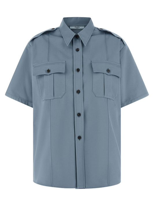 Blouse by Prada for women in cotton blue showcases a sleek silhouette, elegantly detailed with a sleek and short-sleeve for a sleek finish.