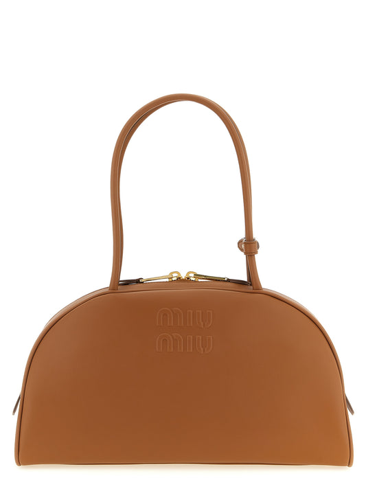 Shoulder Bowling Bag by Miu Miu for women in calfskin leather brown & gold showcases a enviable silhouette, artfully detailed with a secure zipper, organized , and versatile shoulder-strap & handle for a enviable look.