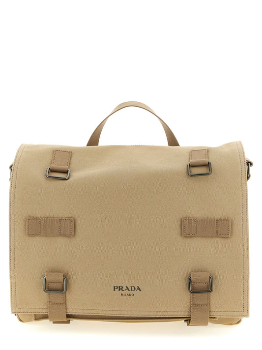 Crossbody Messenger Bag by Prada for men in cotton canvas beige features an fashionable Ribbon Cotton Canvas Crossbody Messenger Bag design with a fashionable flap, ample , and versatile crossbody-strap, shoulder-strap, adjustable-strap & handle for a sophisticated finish.
