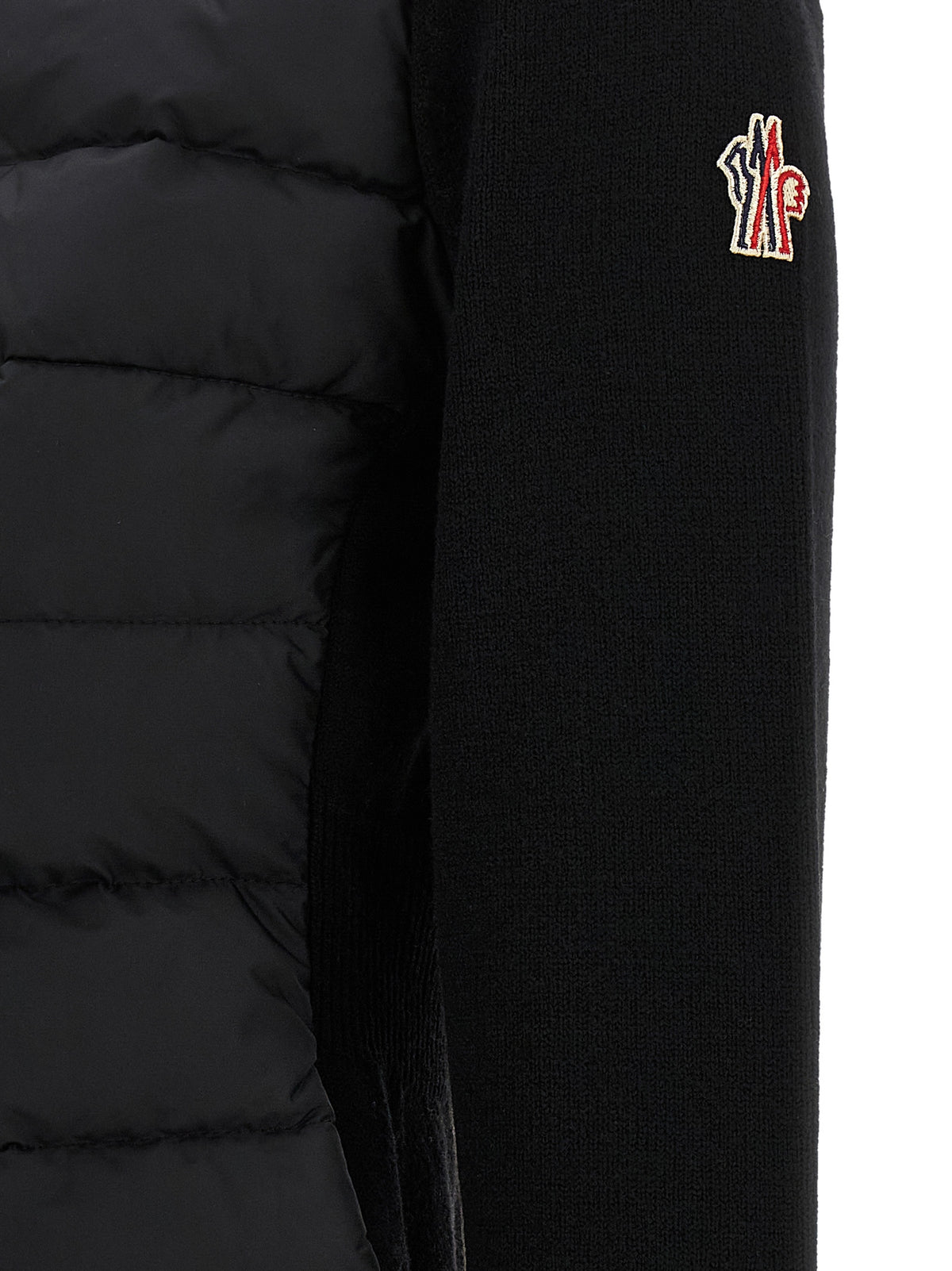 Cardigan by Moncler Grenoble for women in polyamide & virgin wool black showcases a captivating silhouette, artfully detailed with a captivating and for a truly sophisticated captivating look.