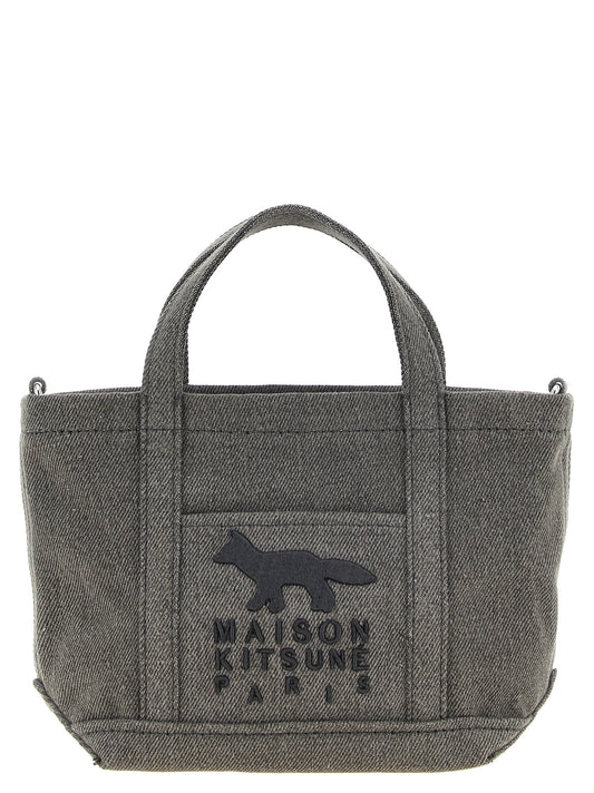 This Mini Tote Bag by Maison Kitsuné for men in denim cotton dark-gray & silver features an on trend Denim Cotton Mini Tote Bag design with a secure zipper, ample external-pockets & internal-pockets, and on trend shoulder-strap, handle, adjustable-strap & detachable-strap.