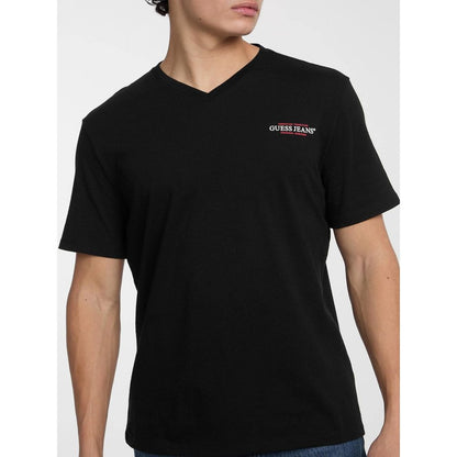 T-Shirt by Guess Jeans for men in cotton black showcases a dramatic silhouette, elegantly detailed with a dramatic and for a truly dramatic finish.