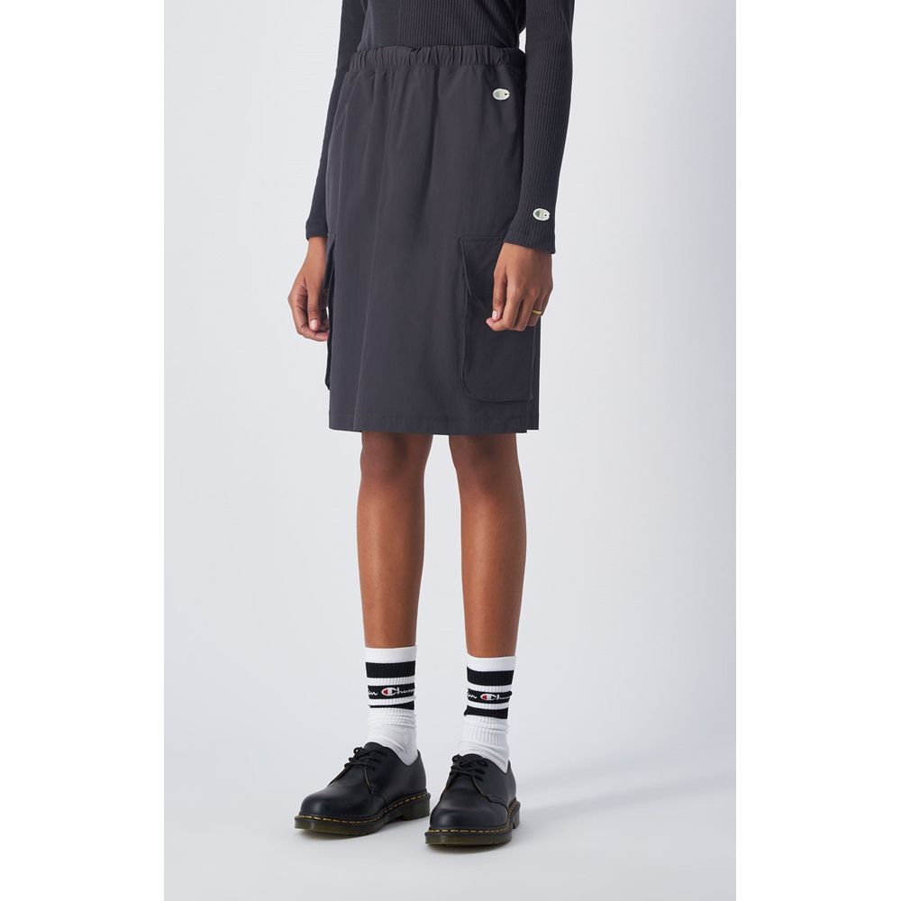 Skirt by Champion for women in stretch polyamide black showcases a dramatic silhouette, artfully capturing the essence of the Women's Stretch Polyamide Midi Skirt in a dramatic midi cut for a refined look.