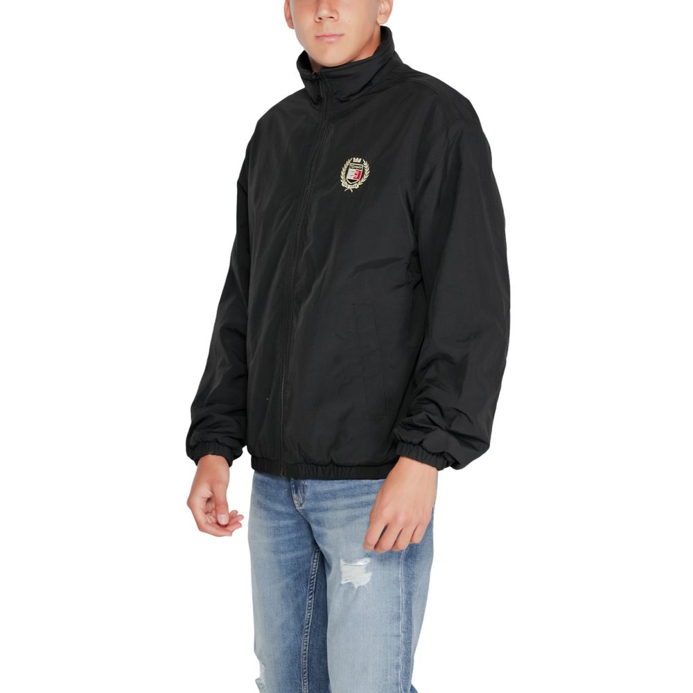 Trench Coat by Tommy Hilfiger Jeans for men in polyester black presents a utilitarian silhouette, showcasing a utilitarian high-collar neckline and sophisticated for a truly utilitarian look.