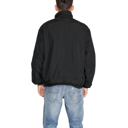 Trench Coat by Tommy Hilfiger Jeans for men in polyester black showcases a contemporary silhouette, detailed with a contemporary high-collar neckline and distinctive for a truly contemporary finish.