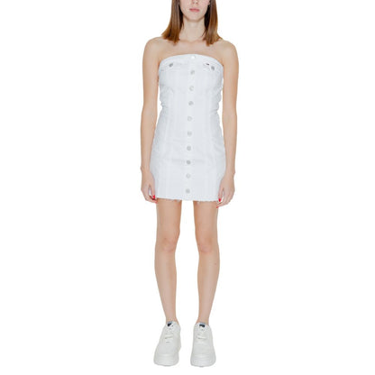 Dress by Tommy Hilfiger Jeans for women in stretch cotton white features a dramatic silhouette, showcasing an elegant and that flows into a dramatic short.
