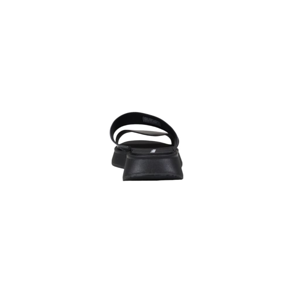 Slider Sandals by Calvin Klein Jeans for women in leather black showcases a sculptural silhouette as Women's Leather Slider Sandals, defined by a sculptural and sculptural for a sculptural look.