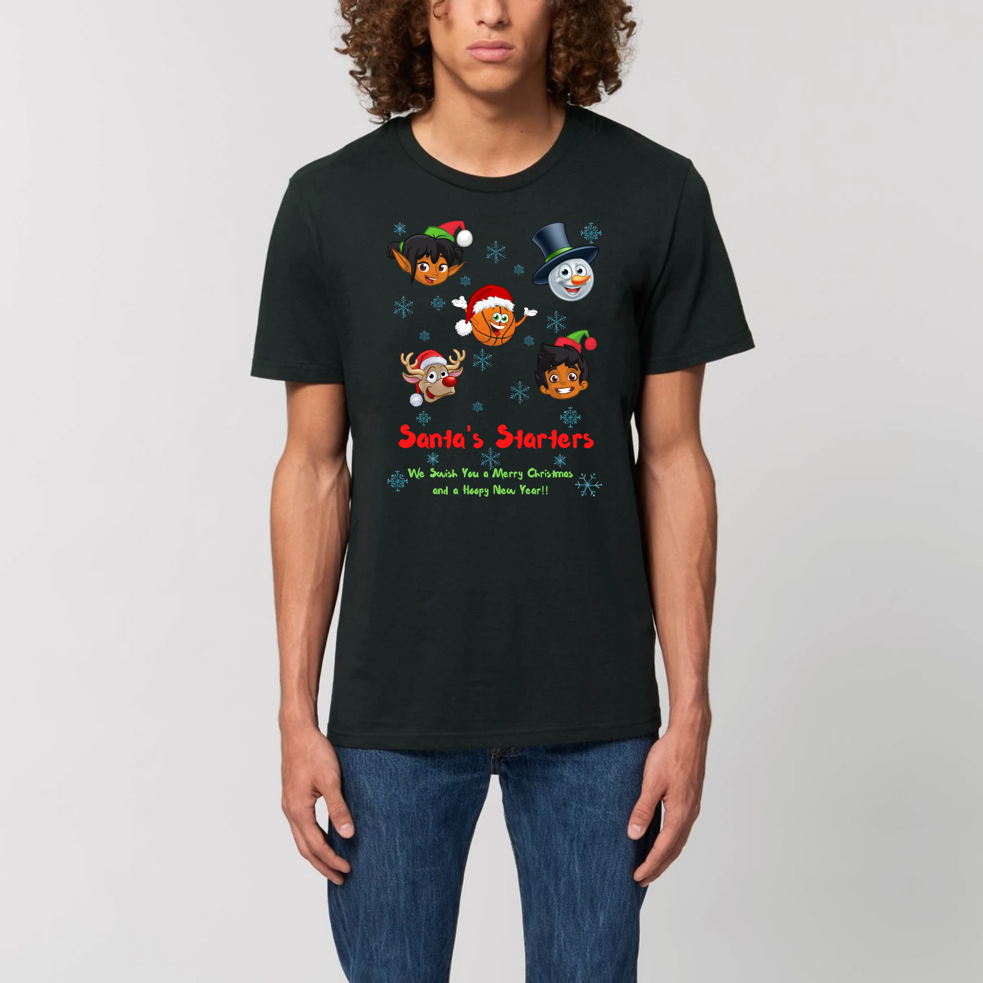 Model wearing a basketball themed Christmas t-shirt with a print design, The design features 5 cartoon character heads of 2 elves, a snowman, Rudolf and a basketball head with the heading Santa's Starters and sub heading We swish you a Merry Christmas and a Hoopy New Year. The t-shirt is Black