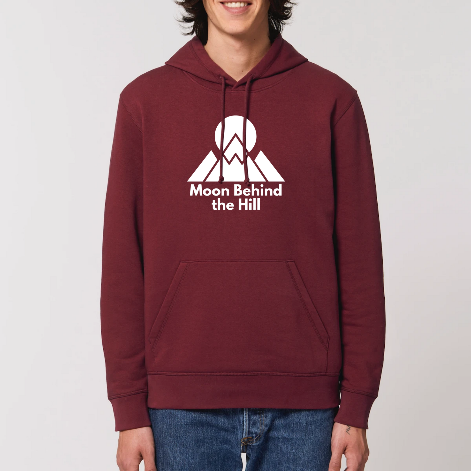 Model wearing a maroon hoodie with a Moon Behind the Hill logo print on the front
